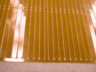 Small Polymer nozzle-plates, micropatterned conical spray orifices